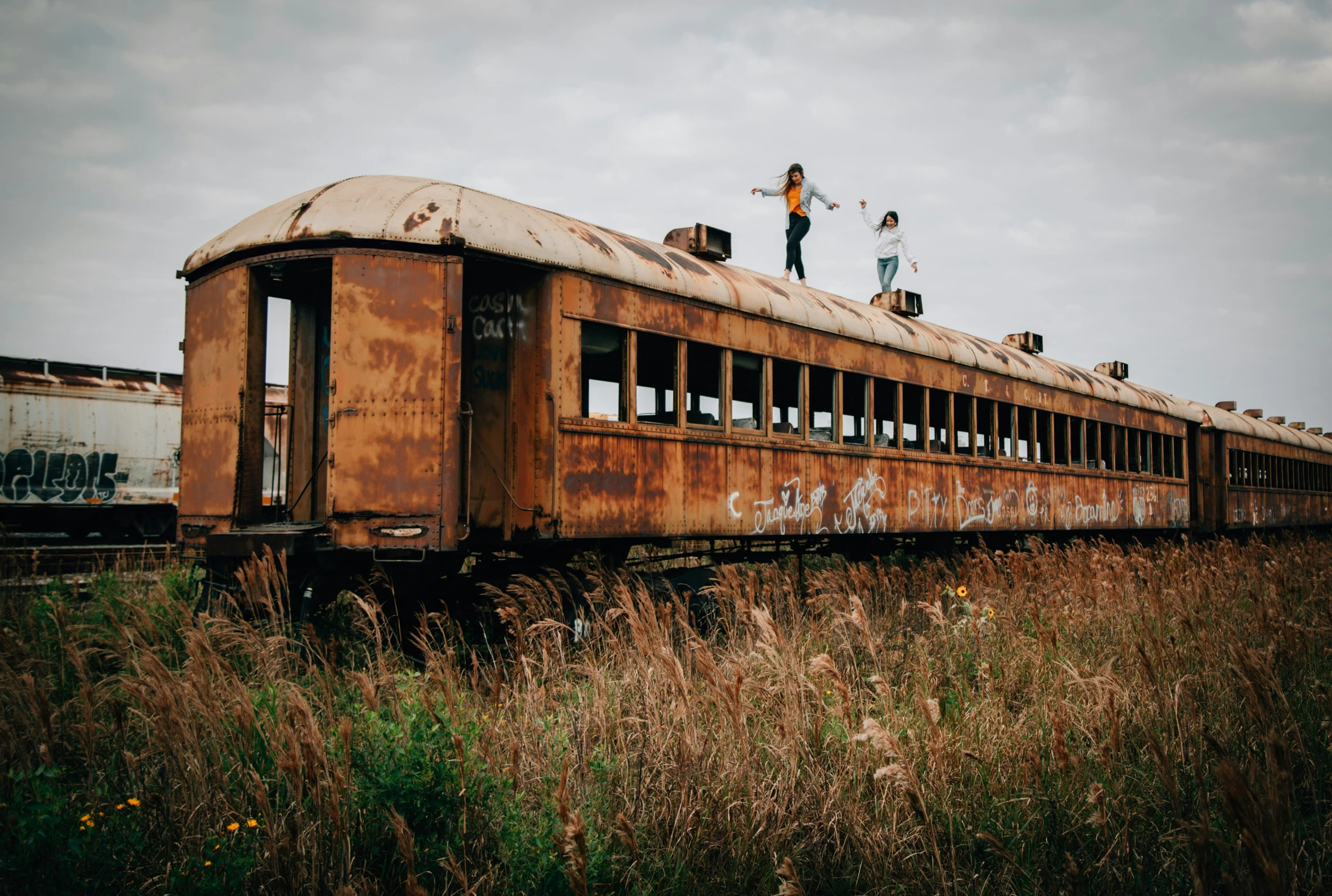 a couple standing on top of an old train