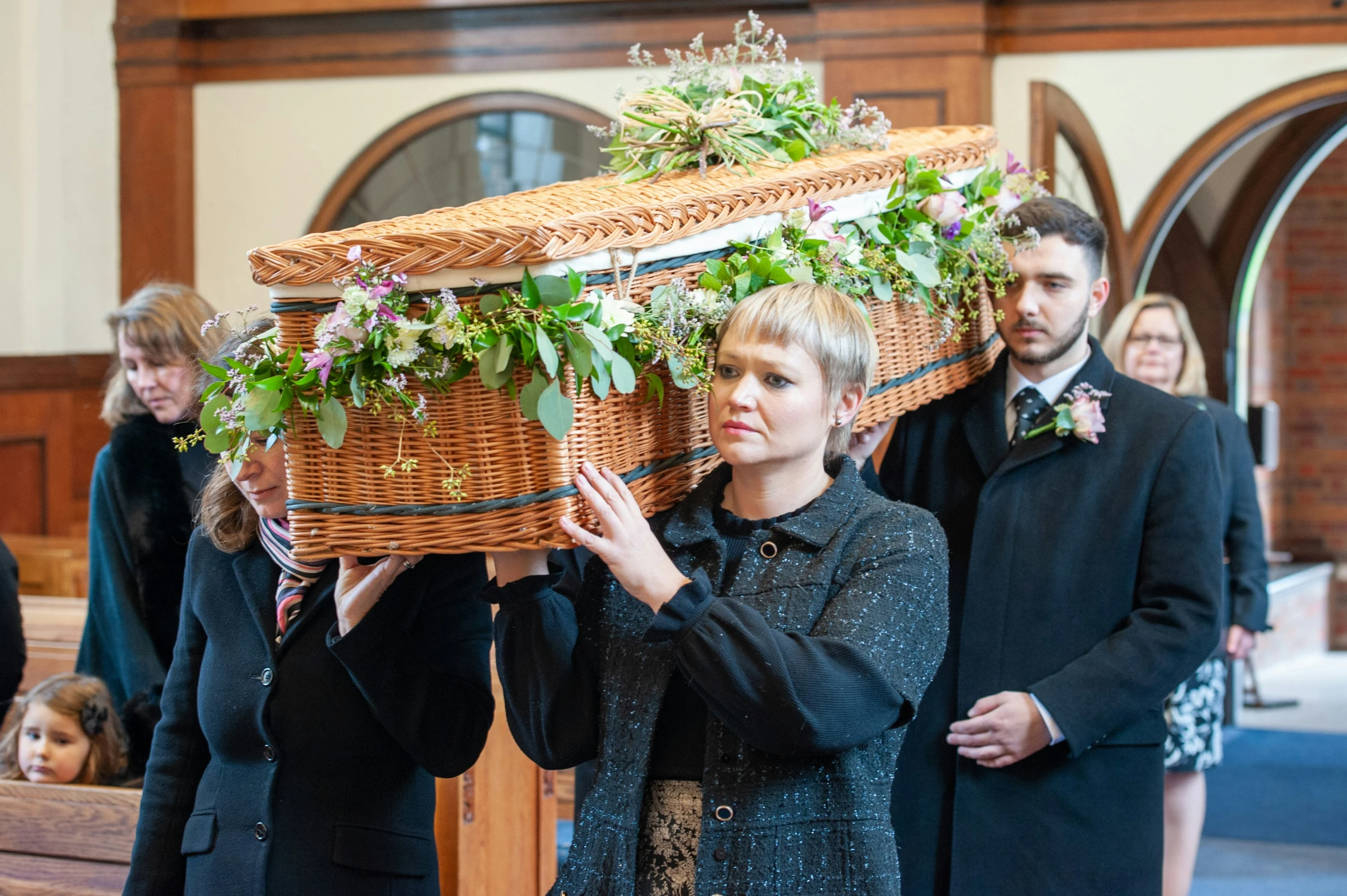 a couple holding a large piece of artwork that looks like an arrangement