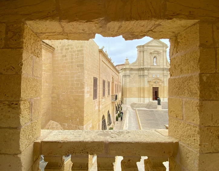 view out of an ancient doorway into a small, old town