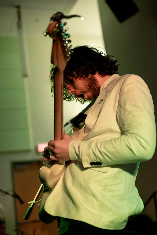 a man that is standing with his guitar