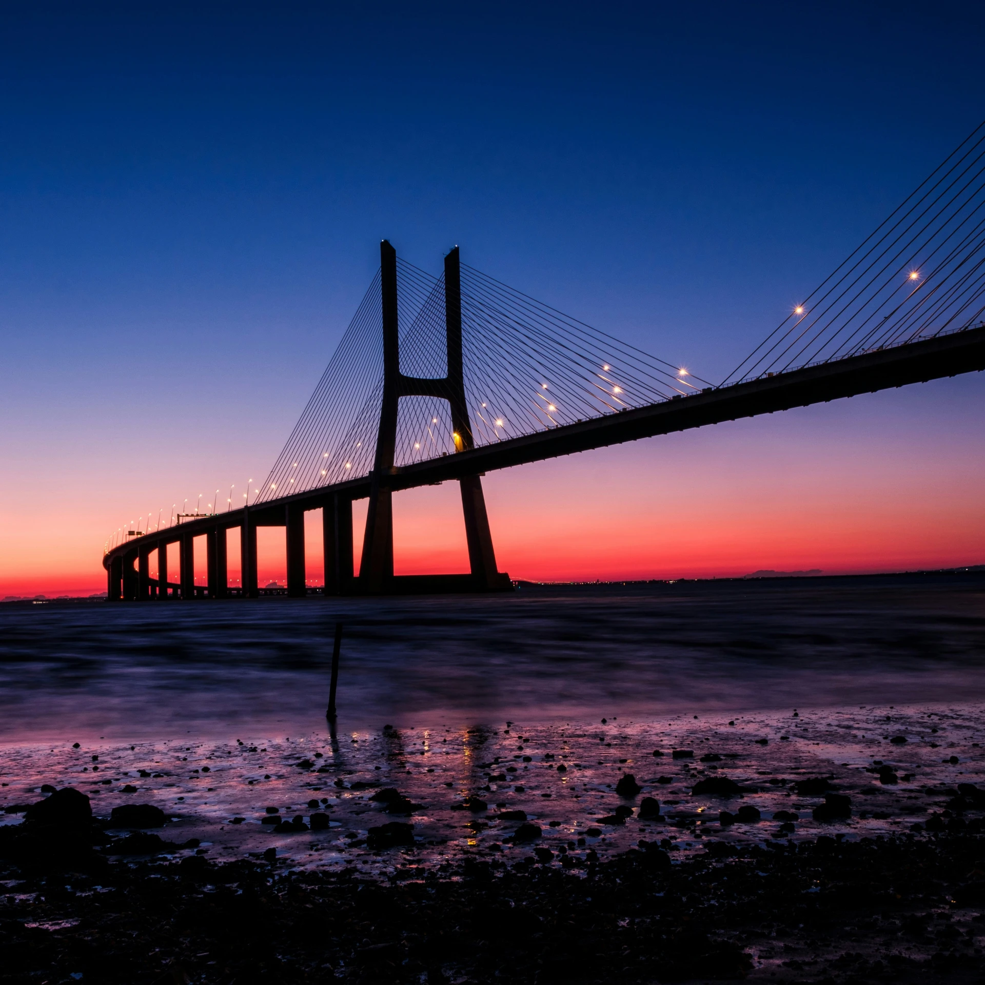 a bridge that has lights on at the top of it