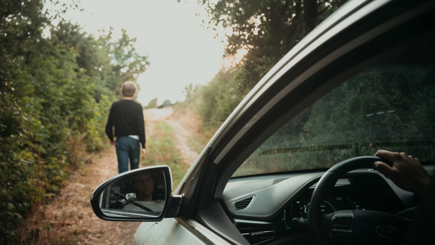 a man that is standing next to a car