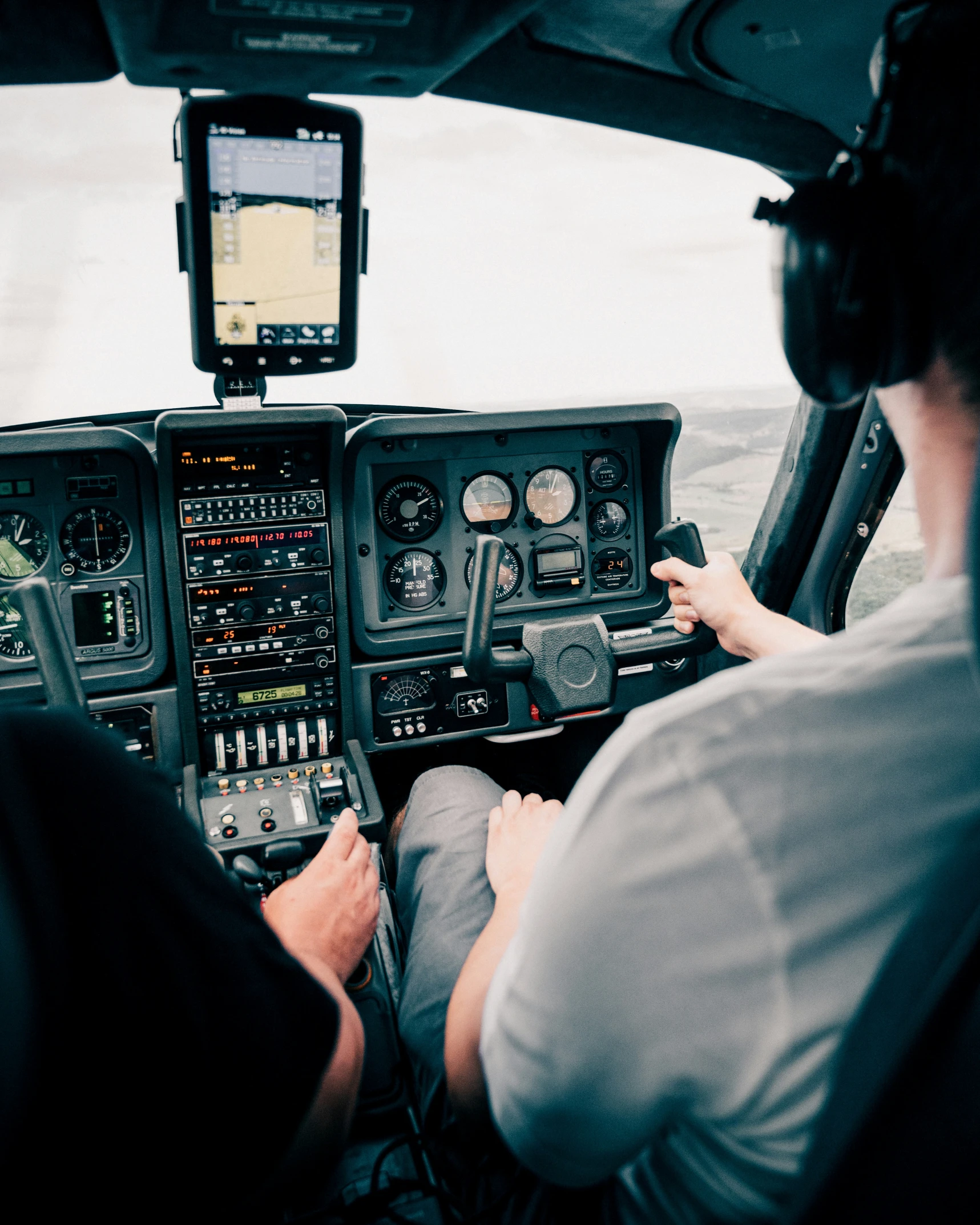 two pilots sitting in the cockpit of a small plane