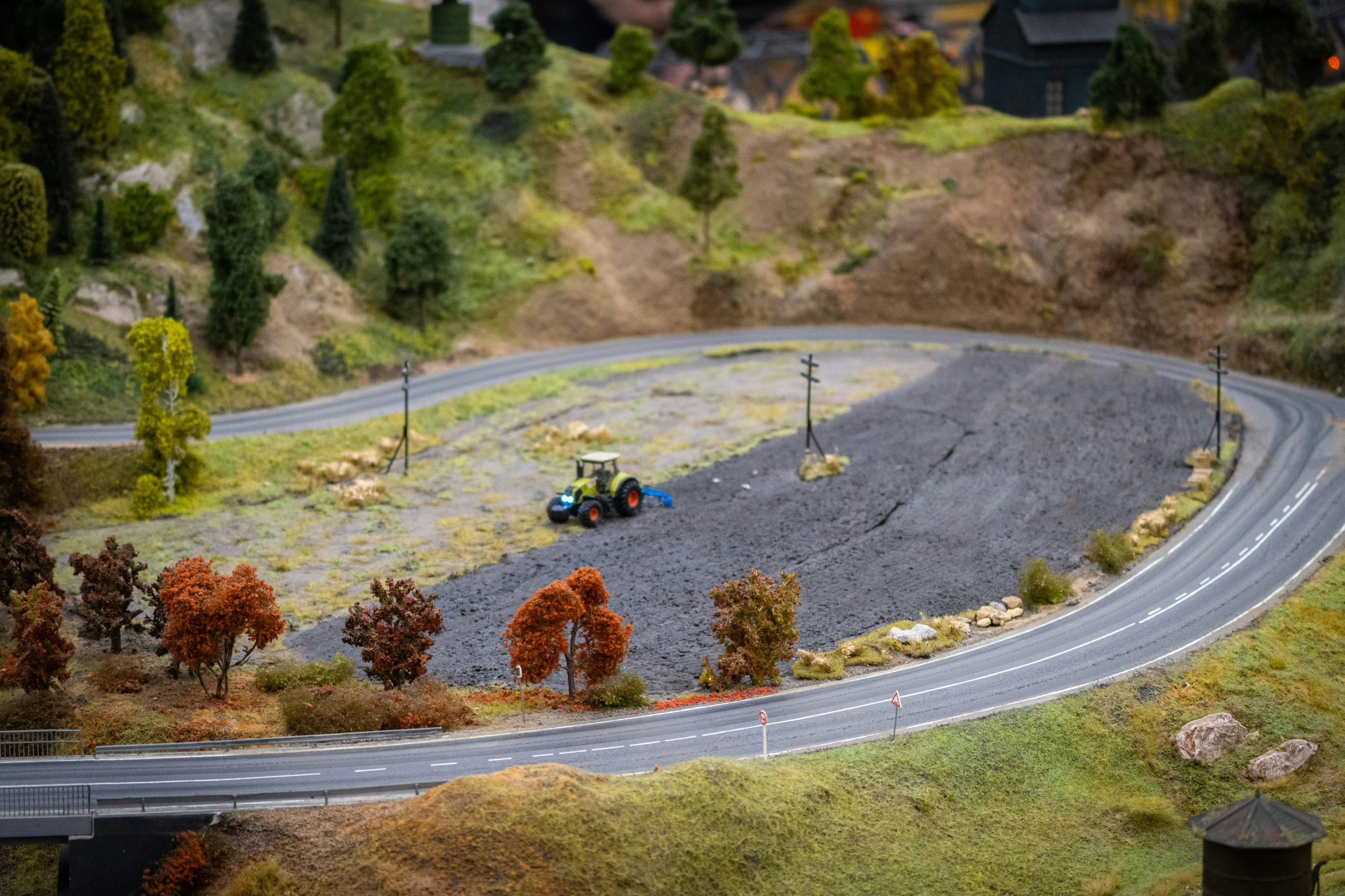 an image of a miniature racing track with toy trucks driving