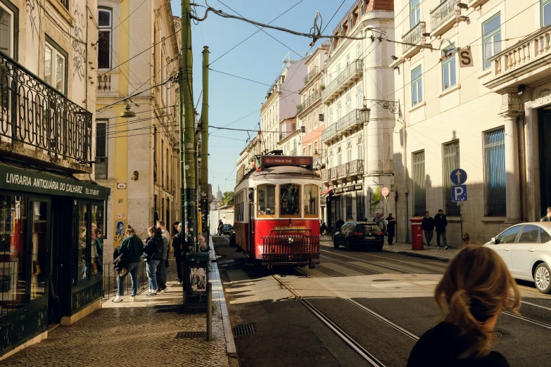 a street scene with a tram going down the street