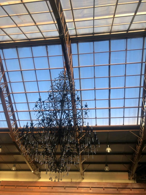 a chandelier in a train station with blue sky