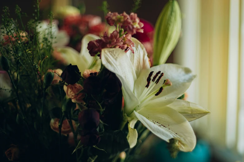 the flowers are sitting in a vase by the window