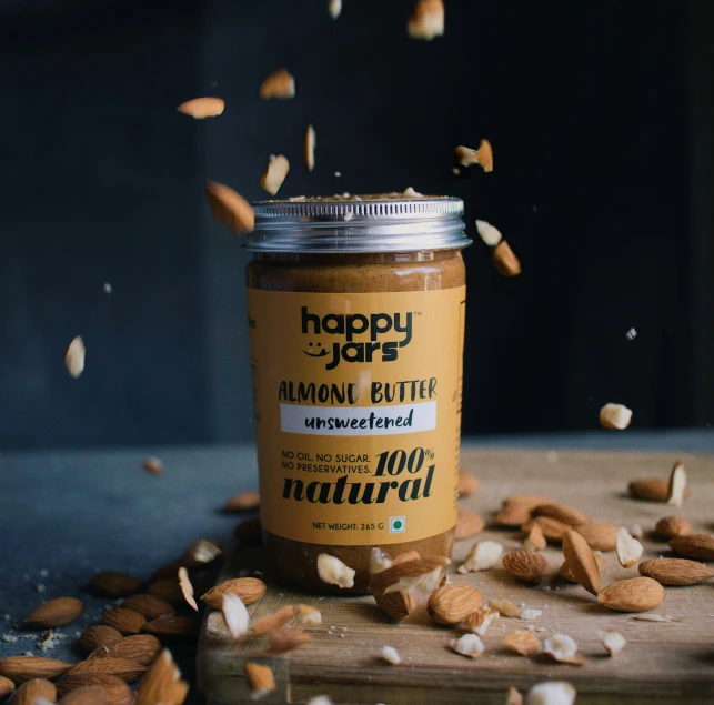 a jar full of almond er sitting on top of a wooden table