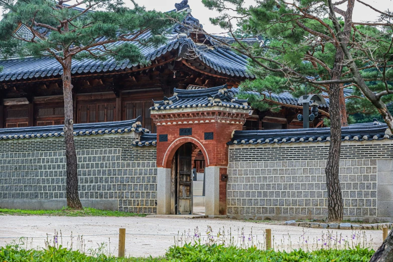 the red and brown building is located near a fence