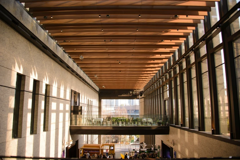 a long hallway with many glass panels on the ceiling