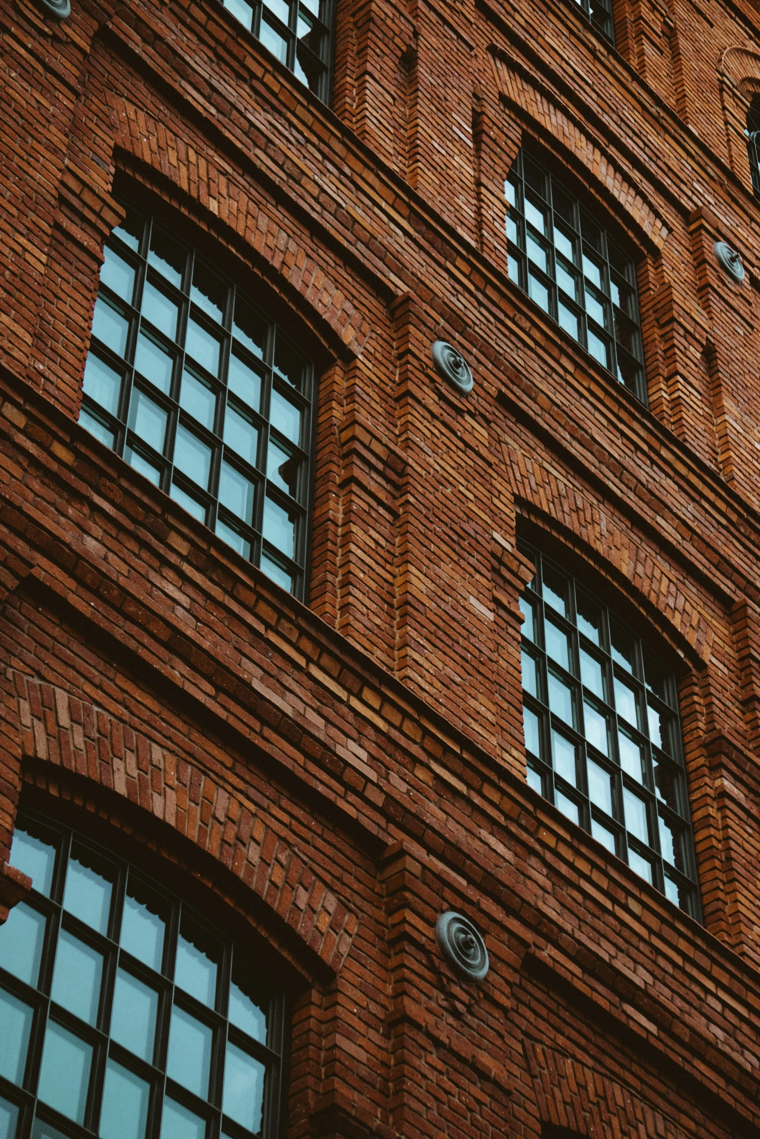 the clock on the side of a building shows eight o'clock