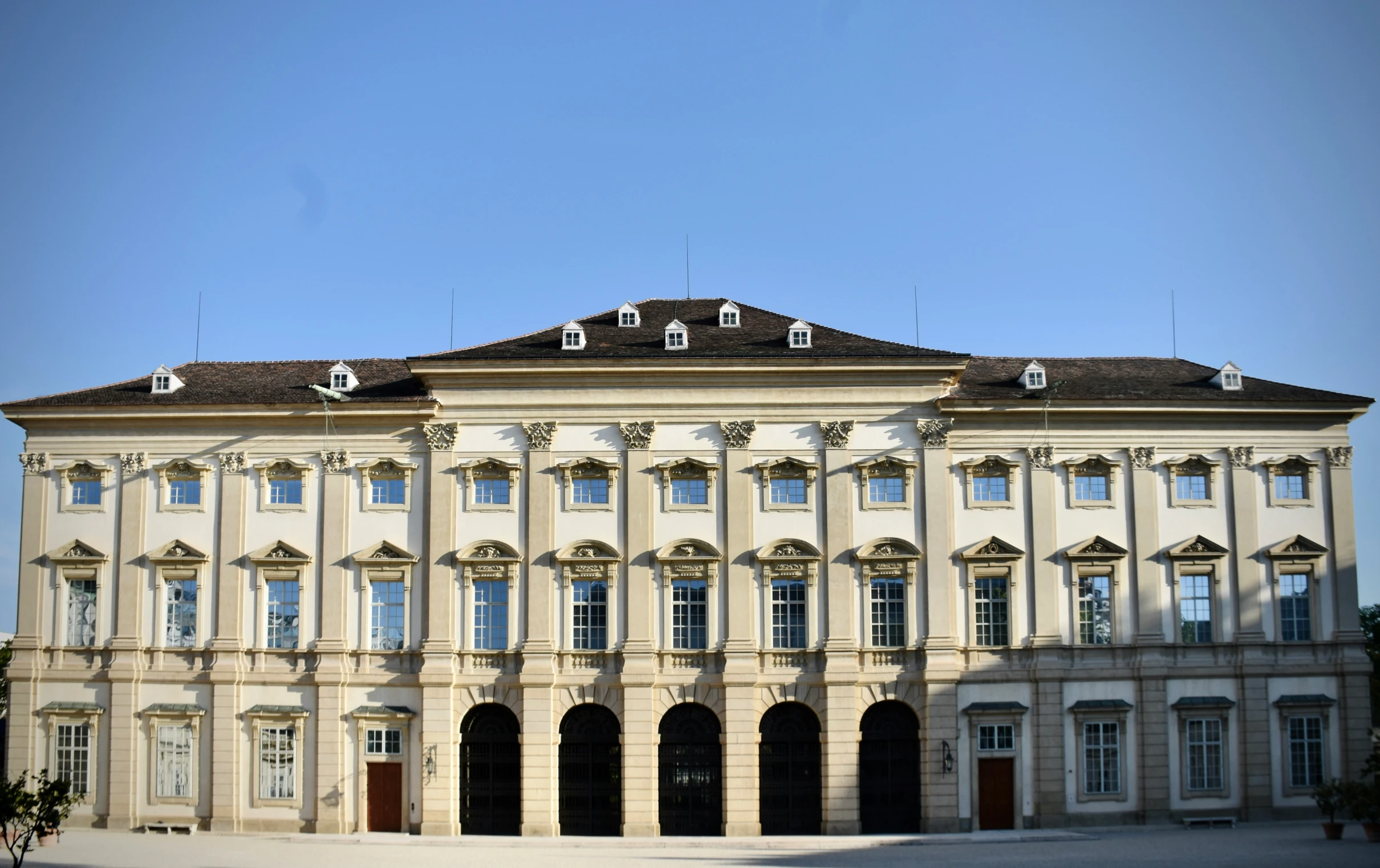 a large building with arched windows and large white doors