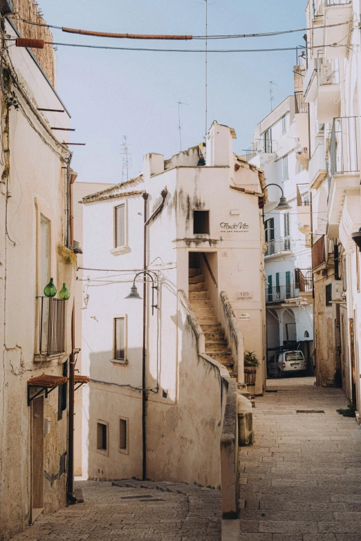 a city street with lots of buildings and a set of stairs