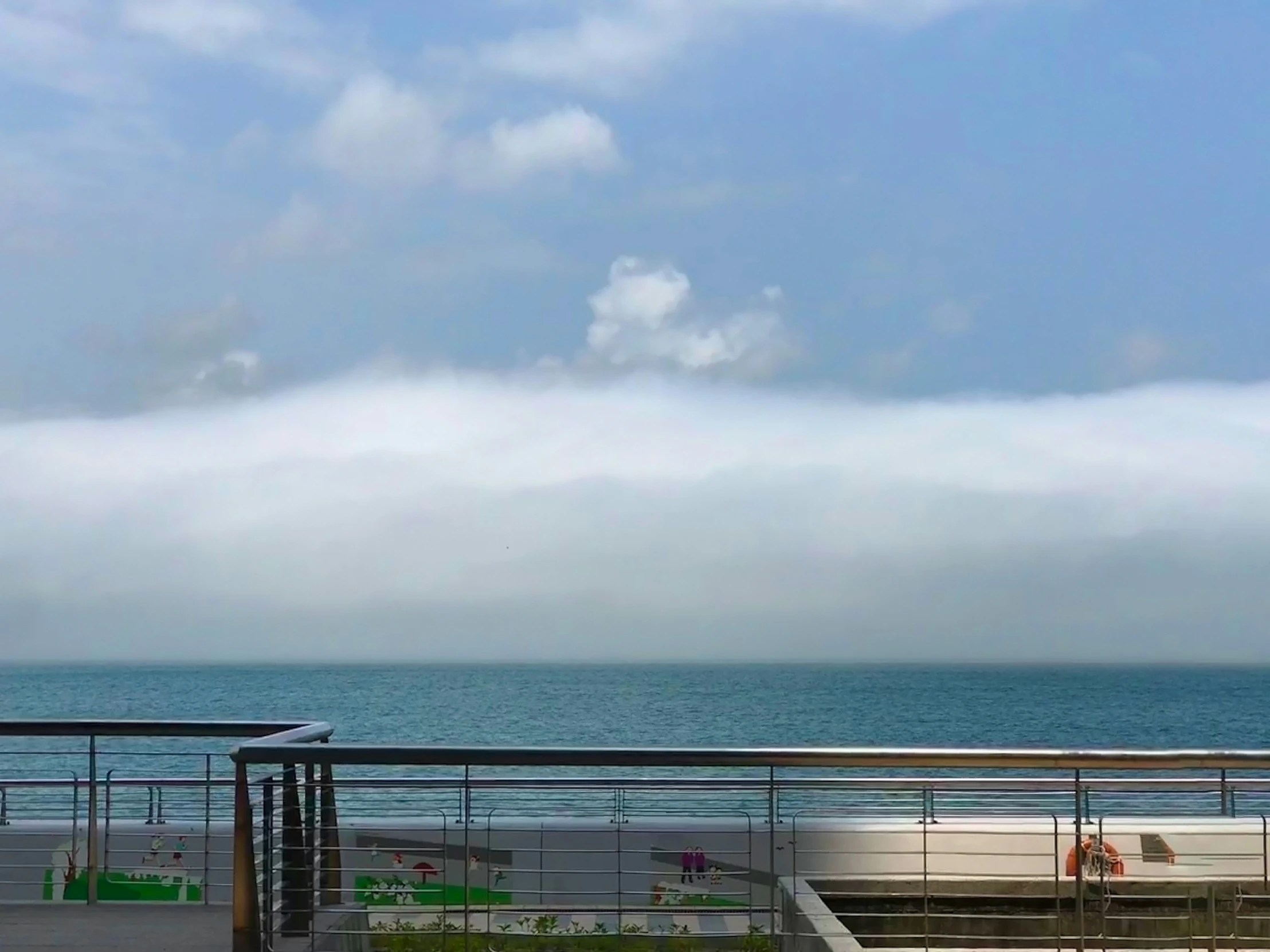 a man is riding his bike along the boardwalk