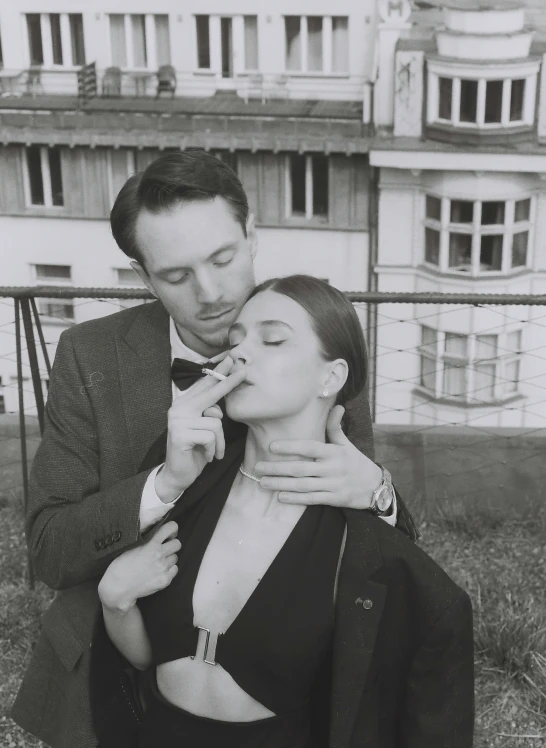 a man helping a woman put on her jewelry