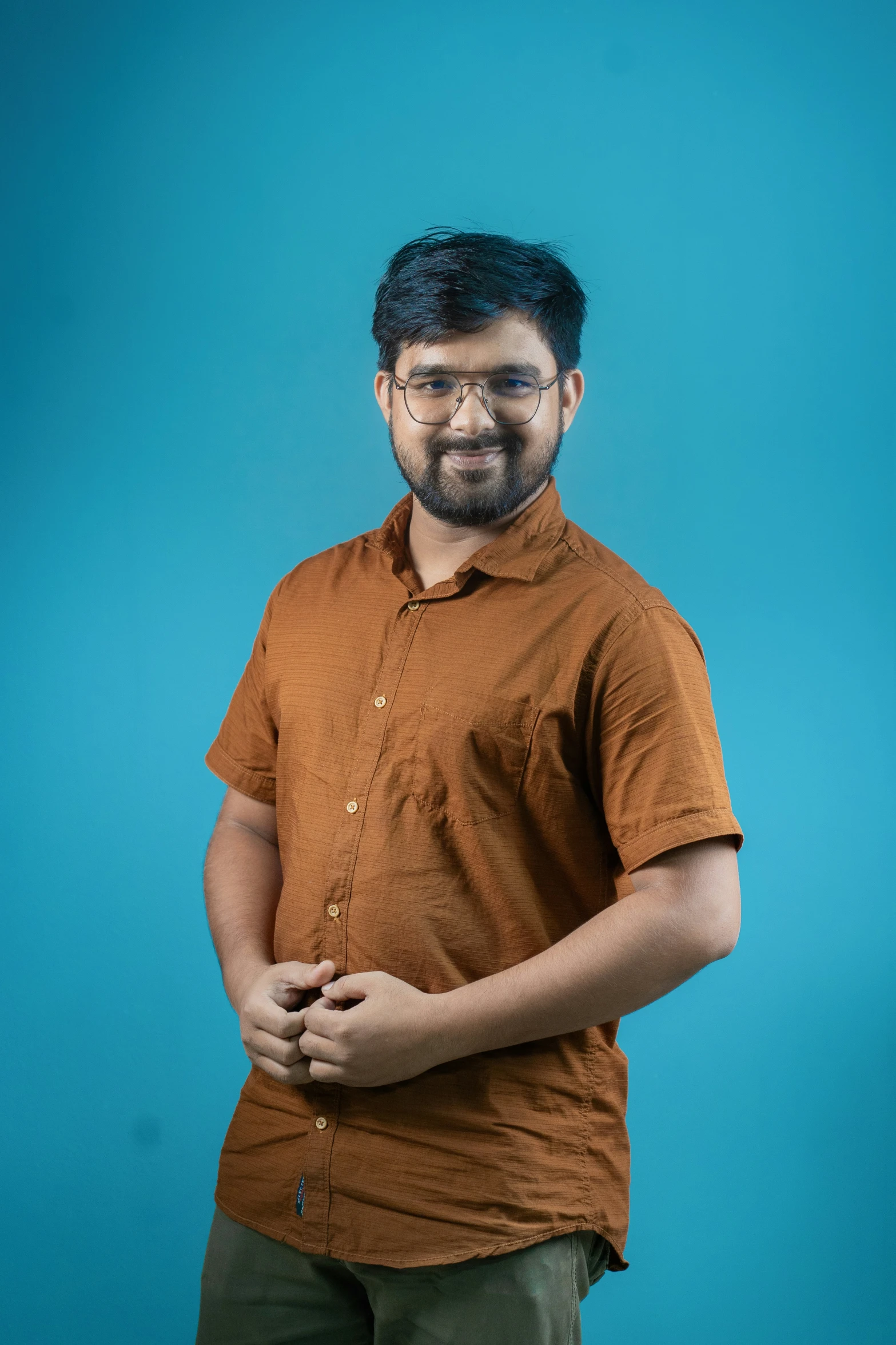 a man standing in front of a blue background