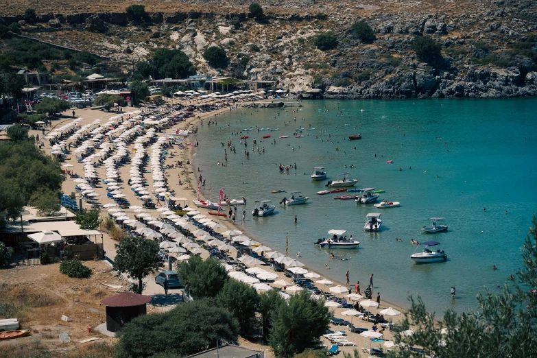 a crowded beach with many people on it