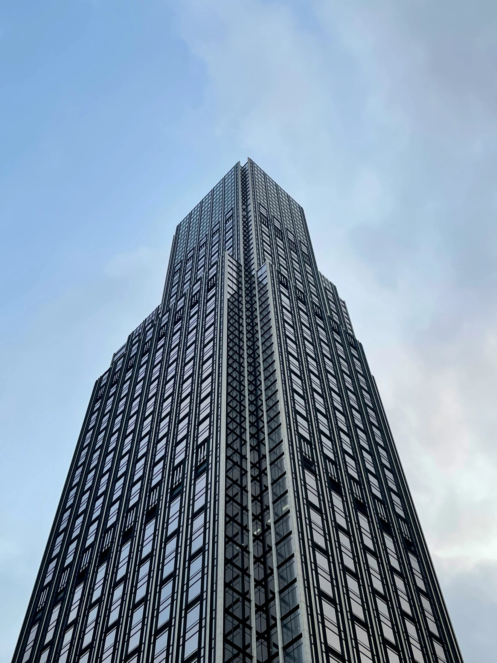 the top of a tall building is shown from below