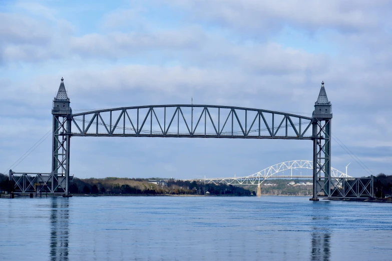 a bridge over water leading to the bridge across it