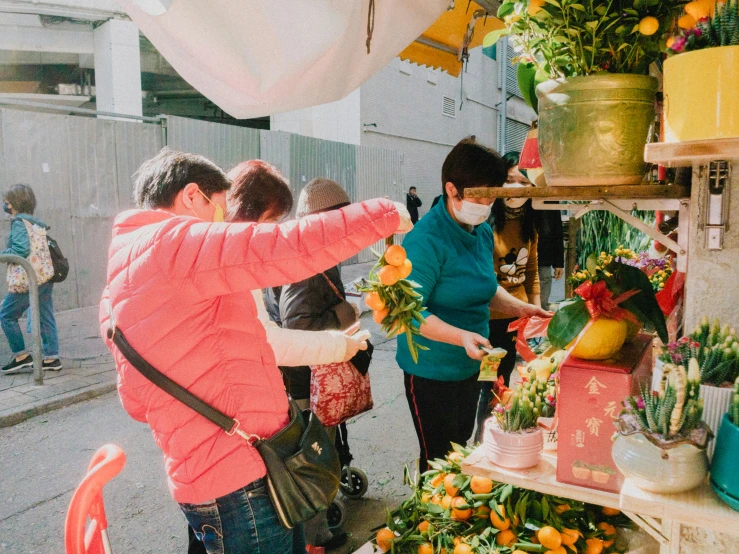 a woman in a face mask shops for floral arrangements