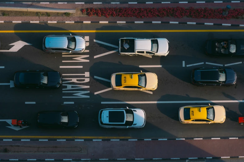 top view of a street intersection with many cars parked in it
