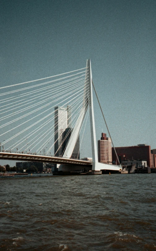 a large long bridge with a building in the background