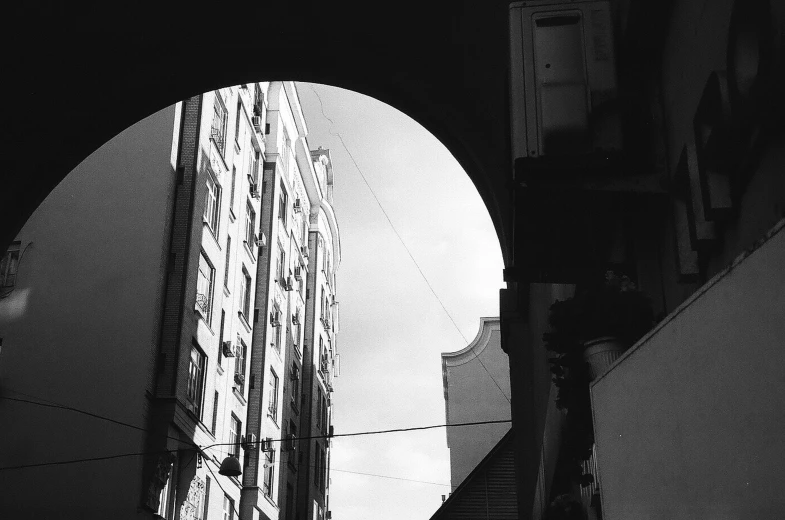 a building and a traffic light in a black and white image