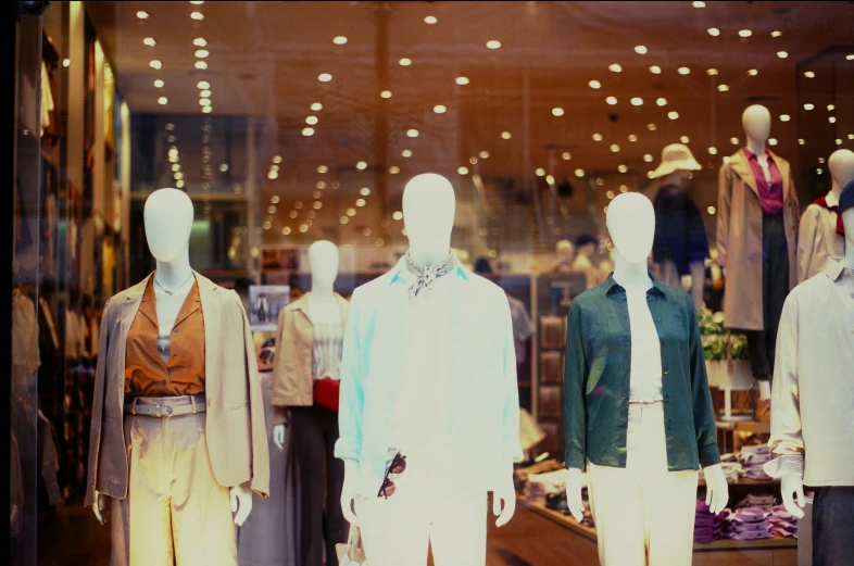 four mannequins are displayed in front of the store
