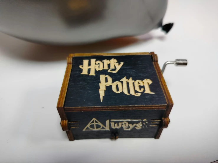 a black and wooden harry potter box and the lid