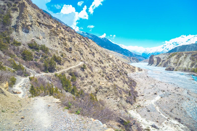 an aerial view of a river near a mountains