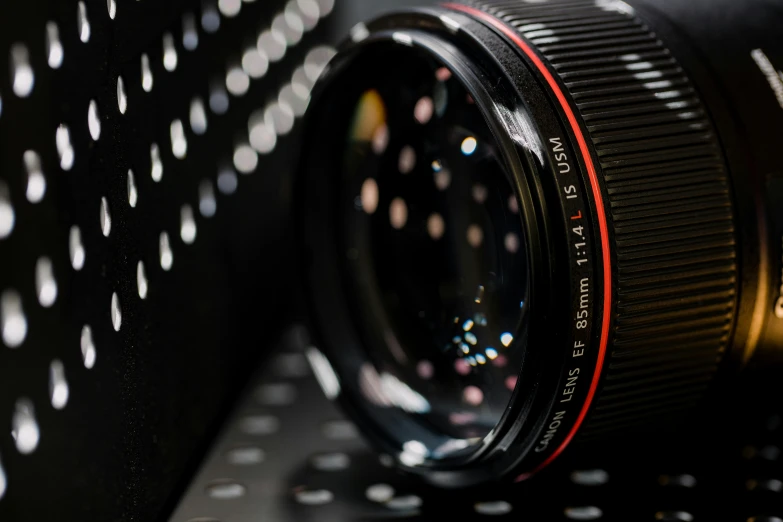 a lens mounted on the side of a black object