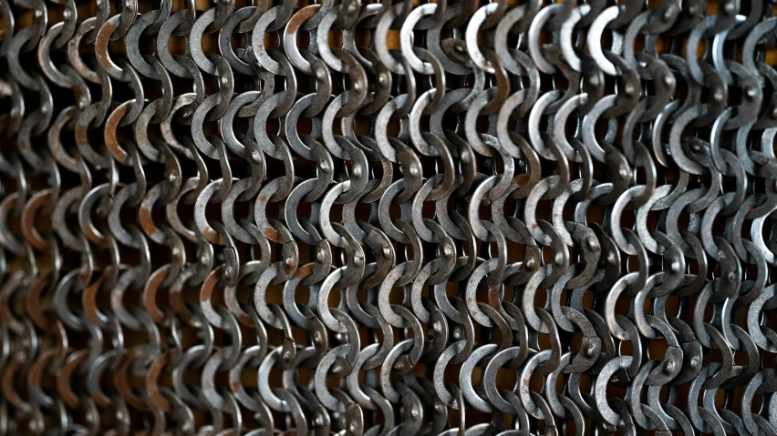 an array of circles are seen behind a chain link fence