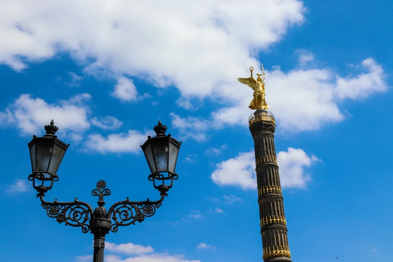 some street lights in front of a cloudy sky