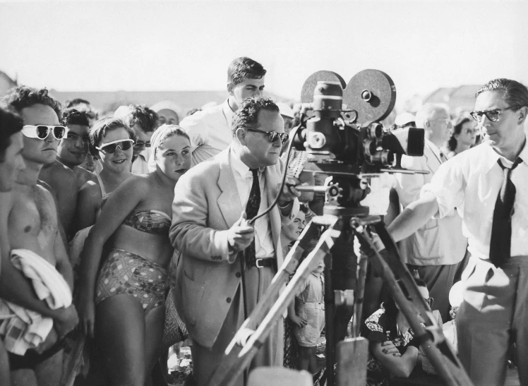 black and white pograph of people near a camera