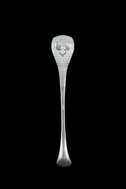a silver spoon on black with diamonds on top