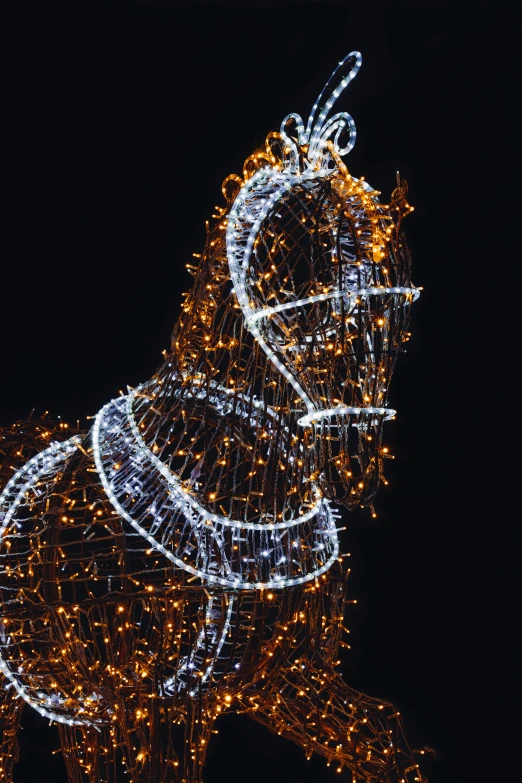 a po of a large statue of a horse that is decorated with christmas lights