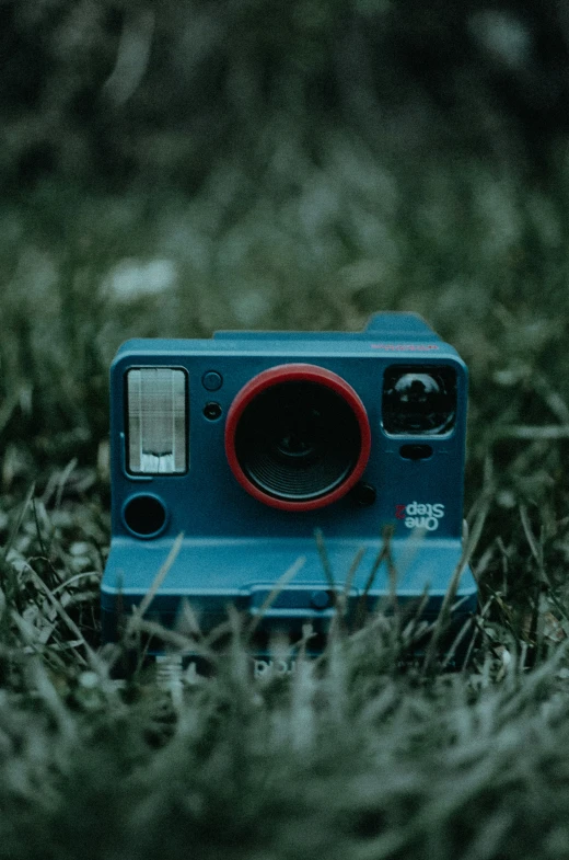 a small camera sitting on top of grass