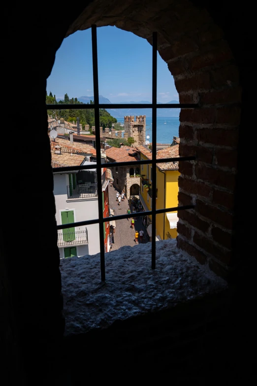 a brick arch over looking the city with people walking