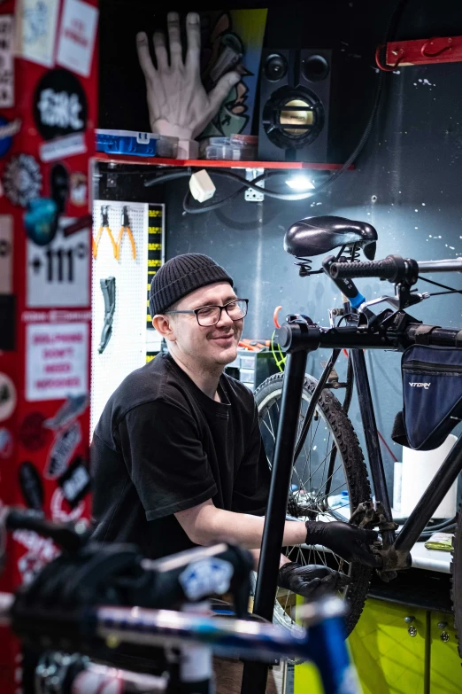 a young man standing next to a bicycle