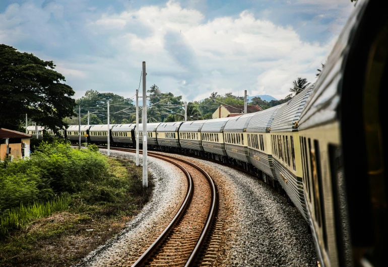 the passenger train goes down the track toward the camera