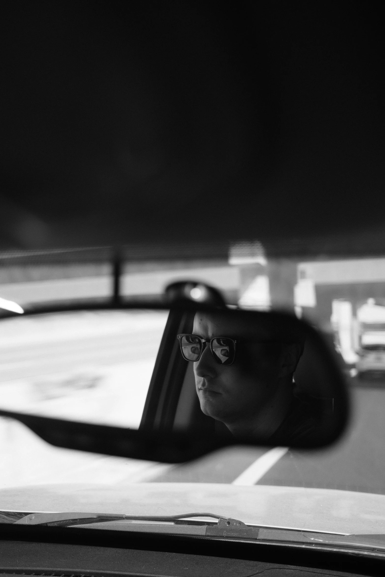 a car with its mirror open looking at it's reflection