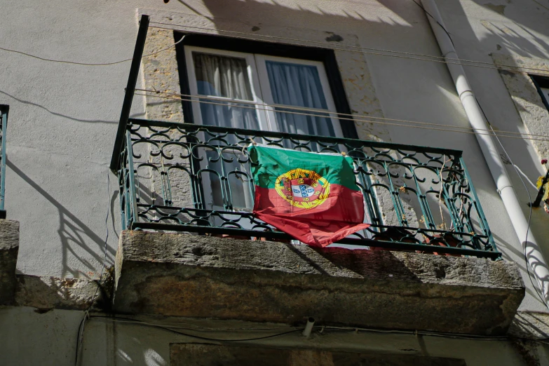 an irish flag is dd across a balcony of a building