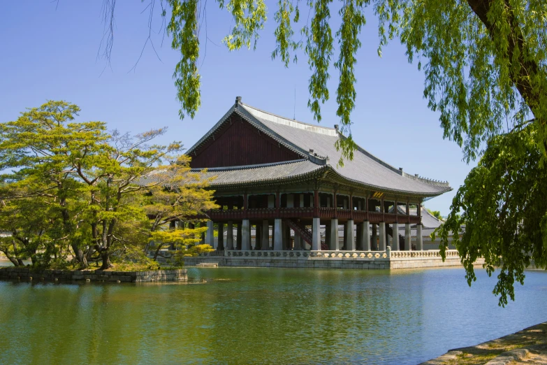 this building is located on a lake and has tall windows