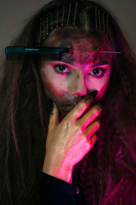 woman with purple makeup holding comb over her face