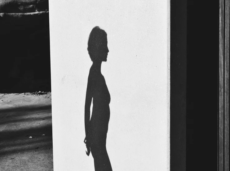 a shadow is seen of a man on the wall