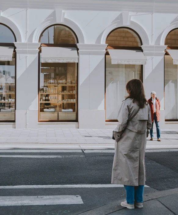 there is a woman walking on the street