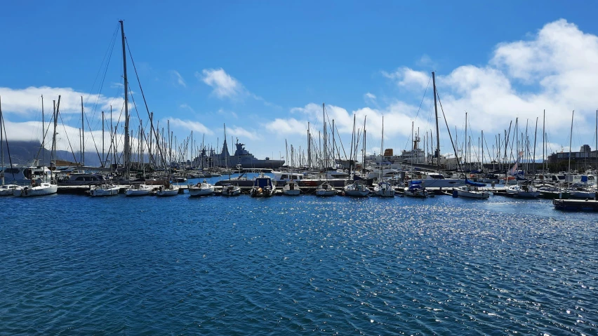 a bunch of sail boats that are floating in some water