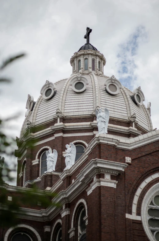 a tall, stone building has statues on the roof