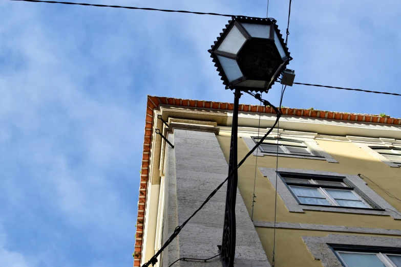 an old fashioned street lamp next to a building