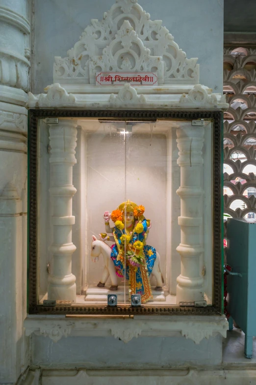 a window display with a decorative carousel set up